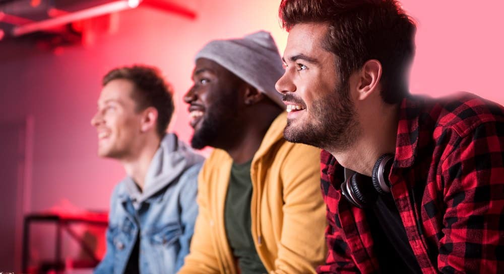 Three male friends watching a comedy.