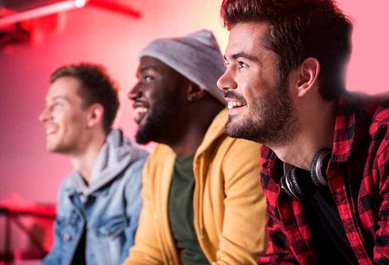 Three male friends watching a comedy.
